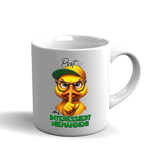 Witzige Enten Tasse mit dem Spruch „Psst... das interessiert niemanden“.
